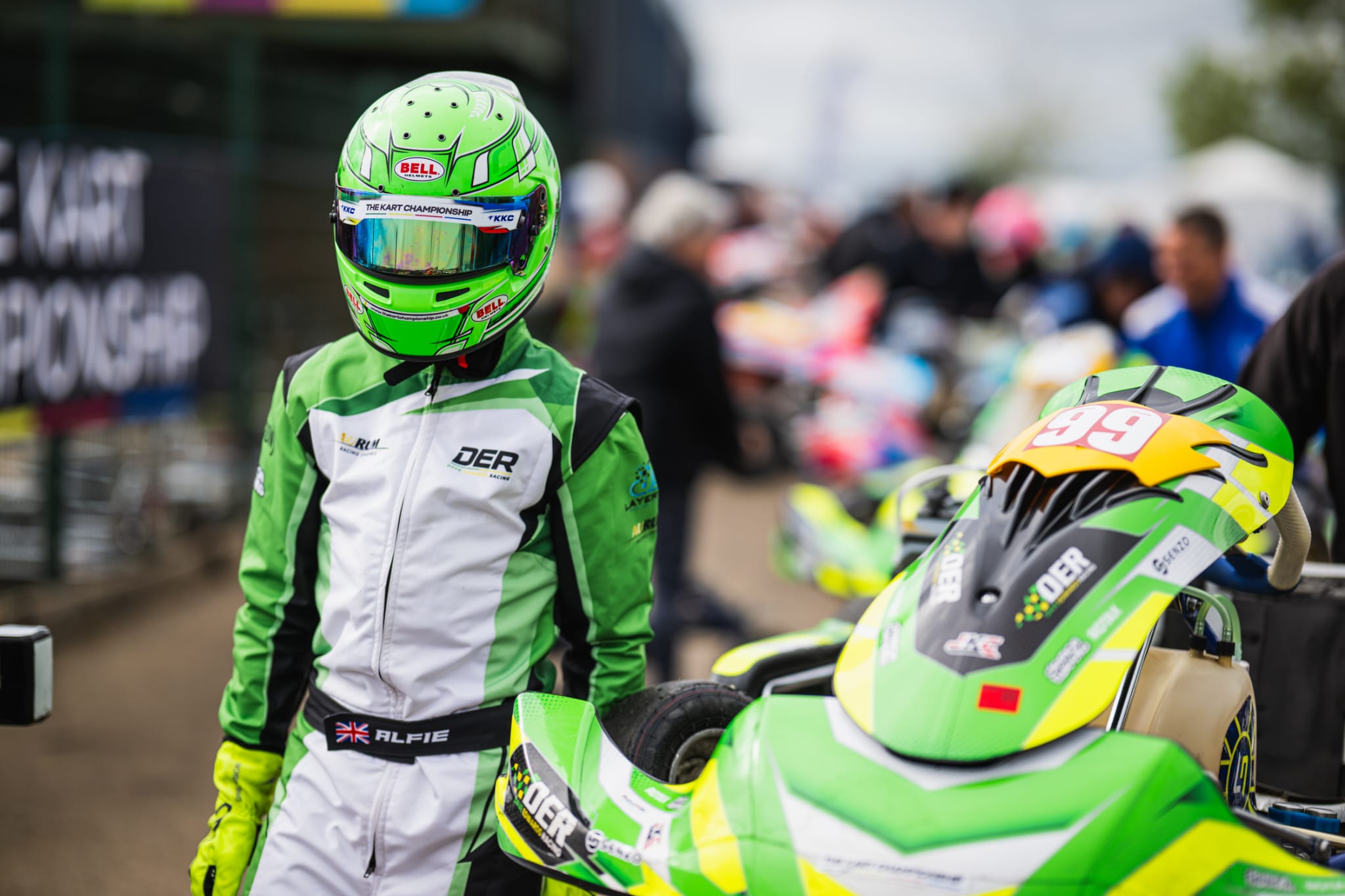 DER driver standing beside kart